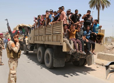 raqi men leave the main military recruiting center to join the Iraqi army after volunteering for military service in Baghdad after authorities urged Iraqis to help battle insurgents.