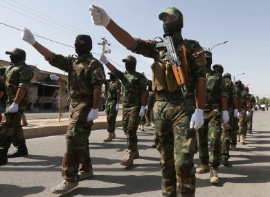 Armed Shiite militiamen, followers of Shiite cleric Muqtada al-Sadr, parade in the northern oil rich province of Kirkuk.