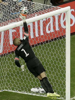United States' goalkeeper Tim Howard deflects the ball over the crossbar during the World Cup round of 16 soccer match between Belgium and the USA.
