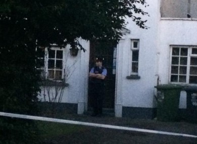 A garda stands at the door of the house where the incident took place.