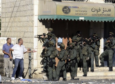 A Palestinian man argues with Israeli border police in Jerusalem yesterday.