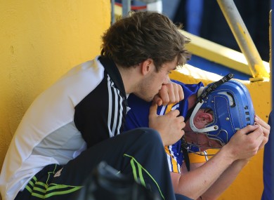 Clare's Shane O'Donnell consoles Podge Collins after he was sent off.