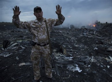 A man gestures at a crash site of a passenger plane near the village of Grabovo, Ukraine.