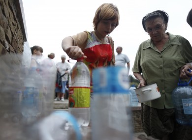 Locals queue to collect water in Donetsk, Ukraine yesterday.