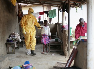 Nowa Paye, 9, is taken to an ambulance after showing signs of Ebola infection.