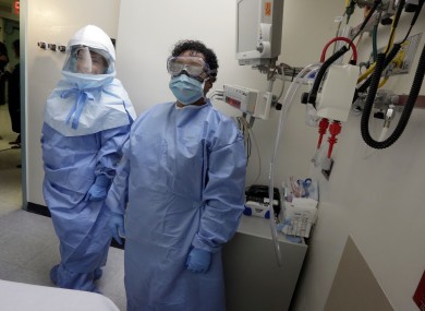 Workers at a Dallas hospital pose in contamination suits.