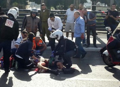 Paramedics treat an Israeli soldier after he was stabbed in Tel Aviv.