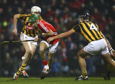 Alan Cadogan is tackled by Jackie Tyrrell.