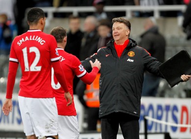 Manchester United manager Louis van Gaal celebrates a vital win with Wayne Rooney and Chris Smalling.