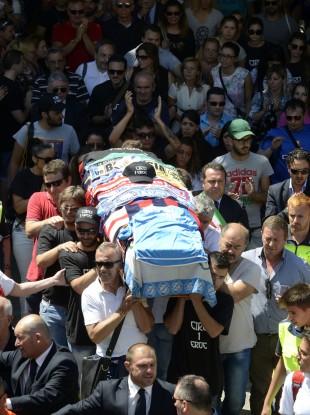 People follow the coffin draped in Napoli shirts and scarves during the funeral of Ciro Esposito.