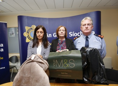 Sergeant Maeve O'Sullivan, Rita Byrne, Principal Social Worker with the Child and Family Agency, Tusla and Superintendent Brendan Connolly holding replica objects in which the baby was left.
