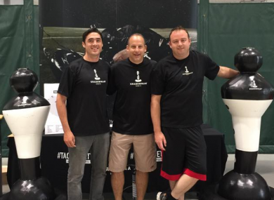 Hartigan, left, with members of the Shadowman Sports team.