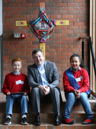 Parish priest Sean Duggan with students Jack Rooney (9) and Sinead Delambaca (12) at the launch of Catholic Schools Week.