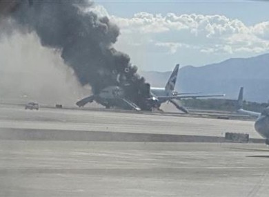 Smoke billows out from the plane at McCarren International Airport.