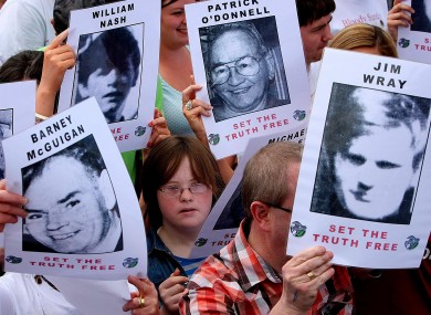 The crowd carry pictures of the victims of Bloody Sunday while they march through Derry in 2010.