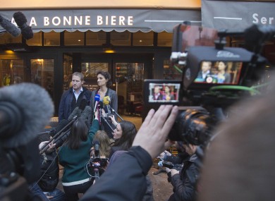 Audrey Bily, right, and Romain Debray, managers of A La Bonne Biere, speak to the media in front of the café today.