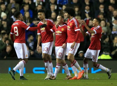 The United players celebrate with Rooney.