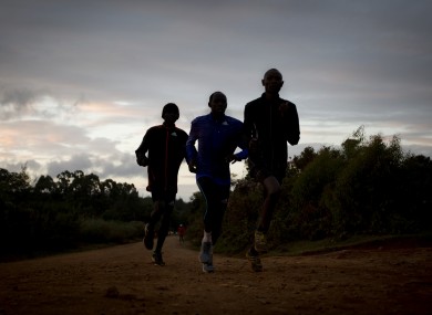 Kenyan athletes train just after dawn in Kaptagat Forest.