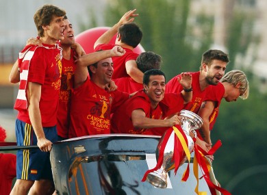Pedro holds the trophy as his Spanish team-mates celebrate in 2012.