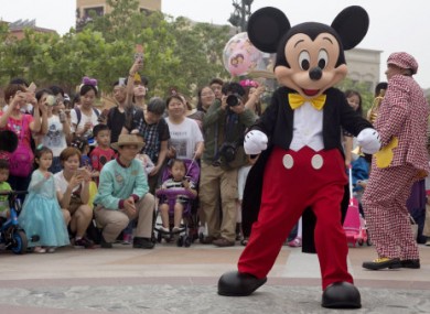 Mickey Mouse entertains visitors on the opening day of the Disney Resort in Shanghai, China.