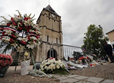 A wreath of flowers next to the church where an hostage taking left a priest dead.