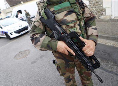 A French soldier stands guard while preventing the access to the scene of an attack in Saint-Etienne-du-Rouvray.