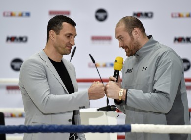 In this 28 April, 2016 file photo, Britain's heavyweight world boxing champion Tyson Fury, right, and challenger Wladimir Klitschko of Ukraine, joke around during a press conference in Cologne.