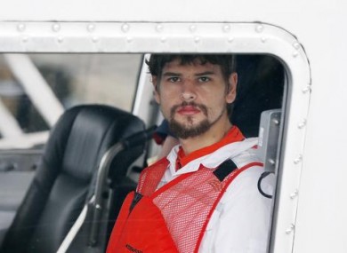 Nathan Carman arrives in a small boat at the US Coast Guard station in Boston today.