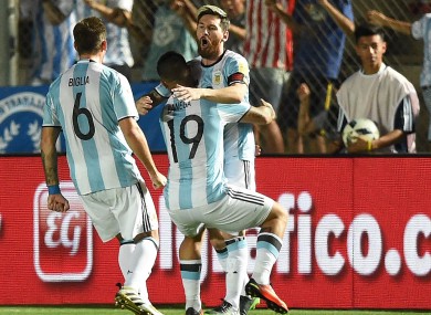 Argentina star Lionel Messi is hugged by team-mates.