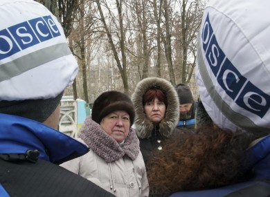 Local residents speak with OSCE monitors in Avdiivka, eastern Ukraine, yesterday.