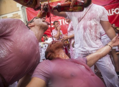 Revellers drink wine at the start of the festival.