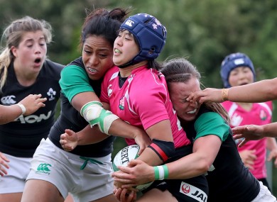 Sene Naoupu and Claire McLoughlin tackle Minor Yamamoto of Japan.