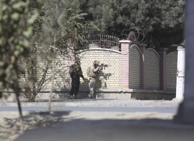 Afghan security personnel take a position near the Shamshad Television after an attack in Kabul.