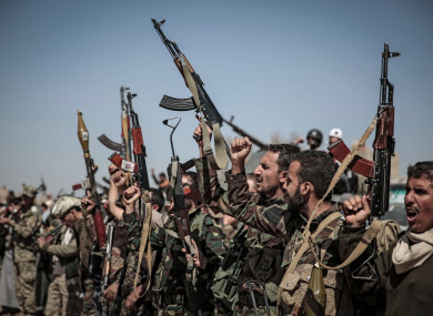 Houthi rebel fighters raise their weapons and chant slogans during a gathering aimed at mobilising more fighters before heading to battlefronts in Sanaa, Yemen.