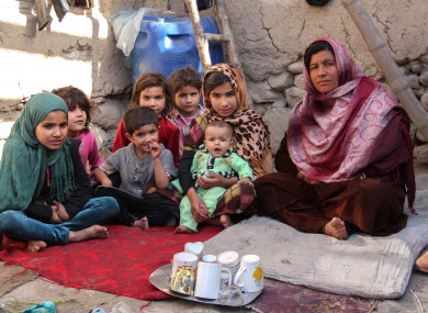 File photo of a widow sitting next to her daughters in her mud-walled house in the women's village of Sanabad, southwest of Kabul, Afghanistan.