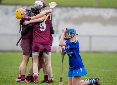 Slaughtneil players celebrate as Niamh Donnelly kneels dejected.
