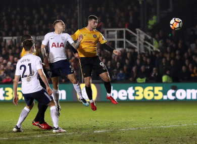 Newport County's Padraig Amond (centre) scores against Spurs.