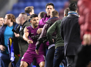 Sergio Aguero is surrounded by fans after Wigan Athletic beat Manchester City.