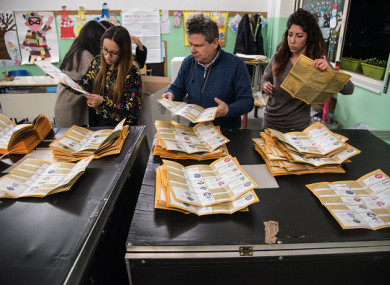 Paper ballots are counted after the end of voting in the Italian general elections.