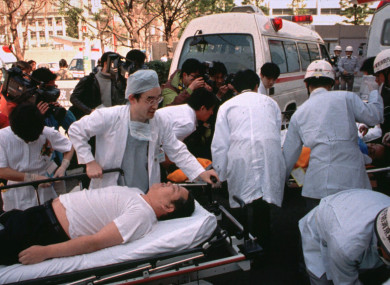 In this March 20, 1995 file photo, subway passengers affected by sarin gas planted in the central Tokyo subways are carried into St. Luke's International Hospital in Tokyo.