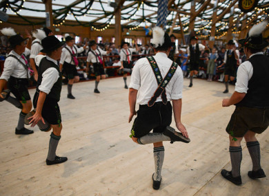 Boys in traditional bavarian Lederhosen perform a 'Schuhplattler' dance.