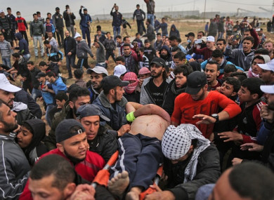 Protesters as they flee during clashes after a demonstration near the border