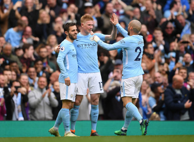 Kevin De Bruyne celebrates with Bernardo Silva and David Silva.
