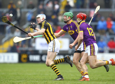 Kilkenny's TJ Reid gets away from two Wexford players.