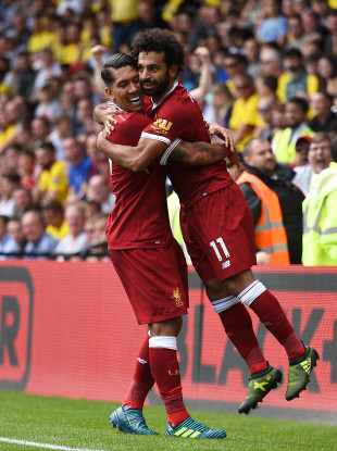 Mohamed Salah celebrates scoring earlier this season with team-mate Roberto Firmino.