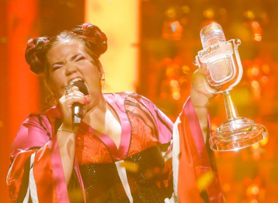 Israel's Netta performs Toy, holding her trophy at the 63rd Eurovision Song Contest.