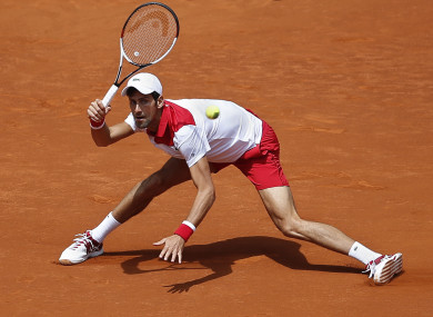 Djokovic returns the ball to Edmund in the second round clash.