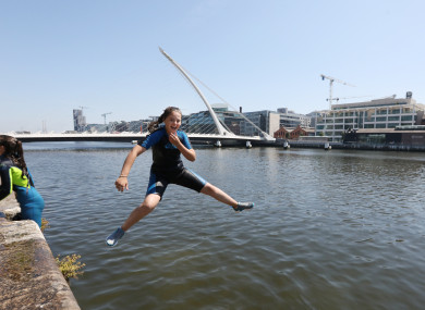 Abbie Butler aged 13 from Dublin jumps into the Liffey at the Convention Centre.