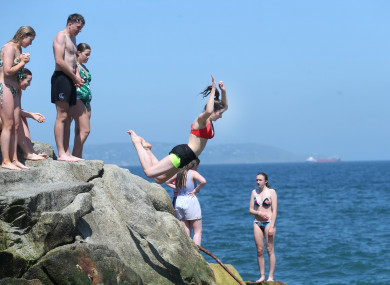 Mary Kate Kiernan from Trim Meath jumps into the sea at the Forty Foot in Dublin during the sunny hot weather.