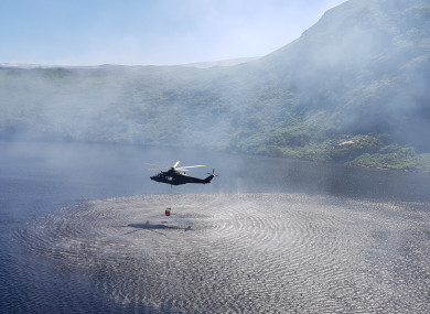 An Air Corps helicopter collecting water from Lower Lough Bray to help combat wildfires.